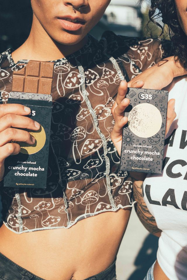 S35 Shroom Chocolate (Crunchy Mocha flavor) held by a lady.